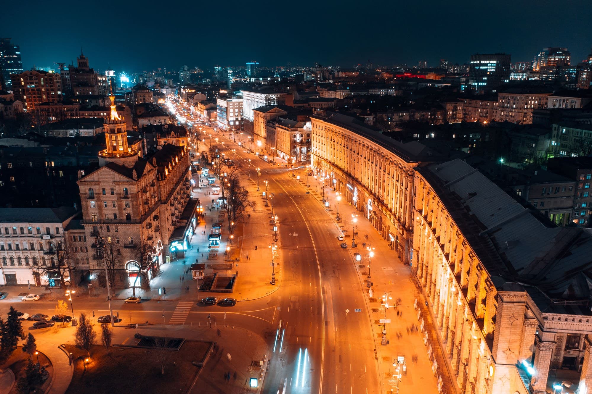 Khreshchatyk in central Kyiv at night, lit windows and traffic running the length of the street.
