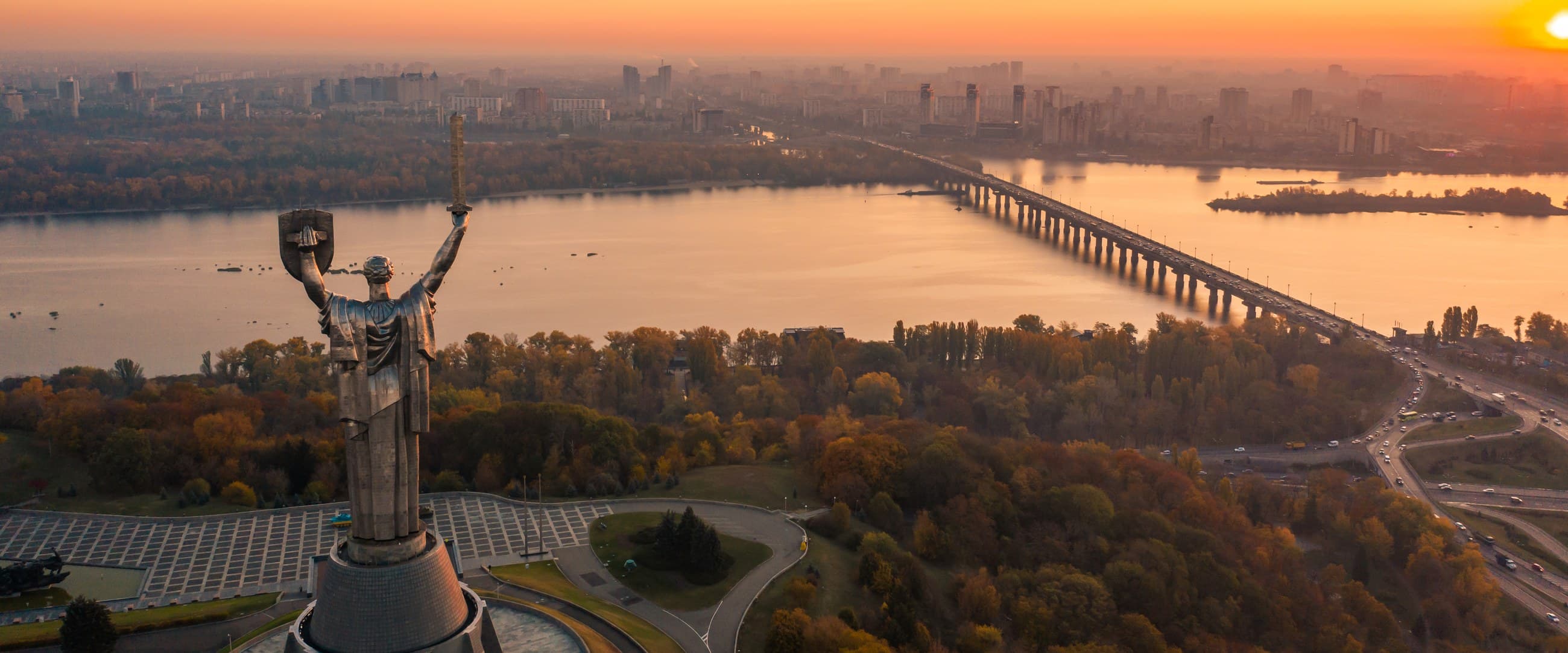Kyiv at sunset, the Dnipro and its bridges running through the city.